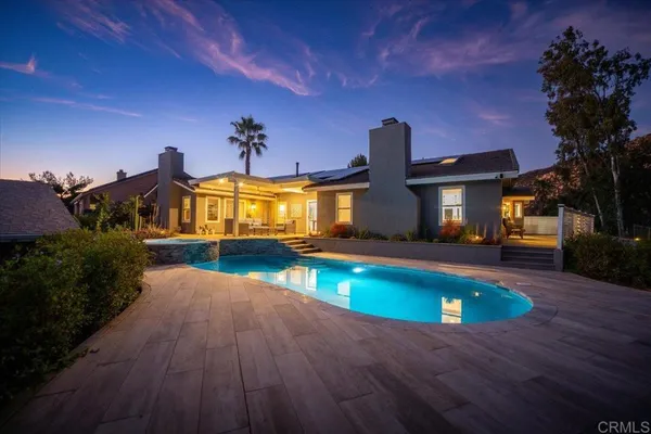 a swimming pool with yard in front of it