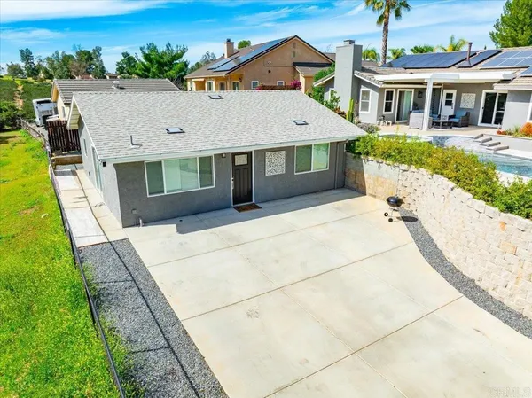 a aerial view of a house with a big yard and large trees