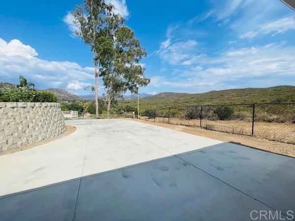 a kitchen with a stove and a wooden floor