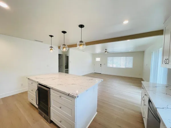 a kitchen with a stove a sink and a refrigerator