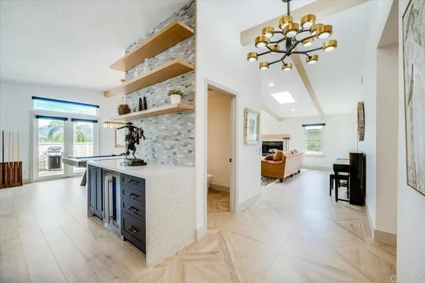 a very nice looking living room with stainless steel appliances