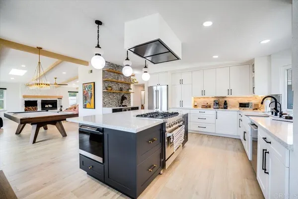 a kitchen with stove and cabinets