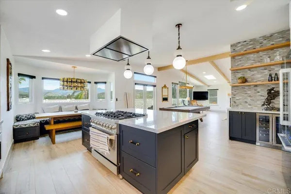 a kitchen with a stove and a wooden floor