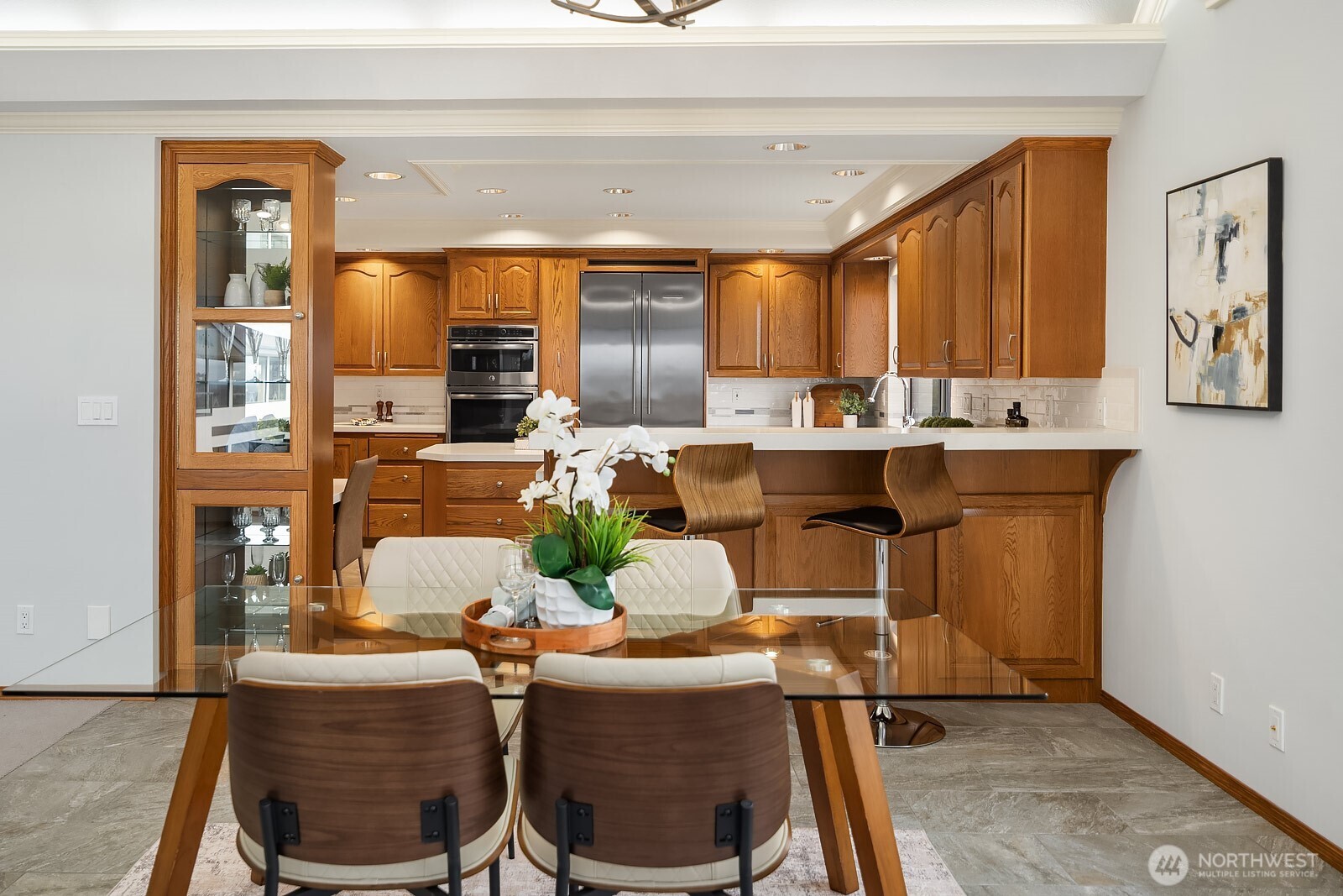 505 Pine Street, Unit 301 Edmonds, WA 98020 - Photo 19 of 40 a dining table chairs next to a window