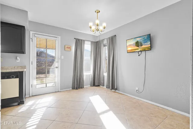 a view of a hallway with workspace and a window