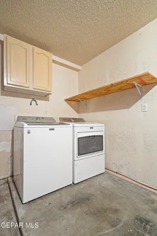 a utility room with sink dryer and washer