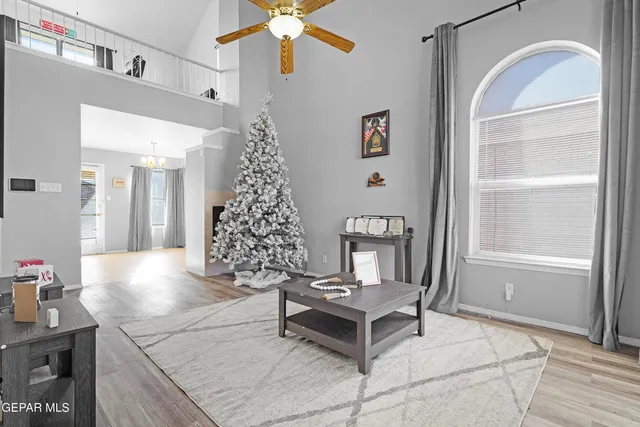 a living room with furniture and a chandelier