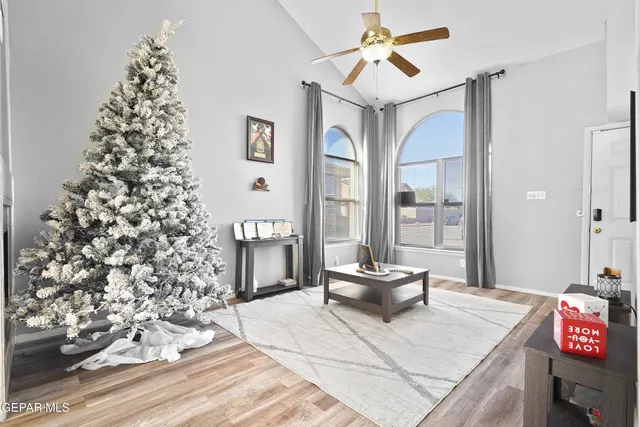 a living room with a large window and chandelier
