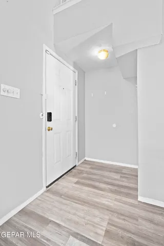 a view of an empty room with wooden floor