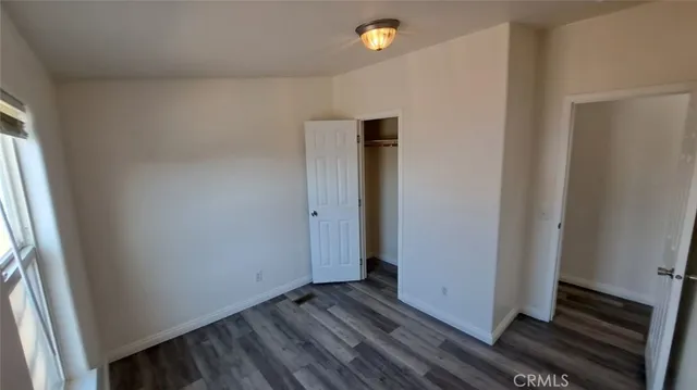 a view of a room with wooden floor