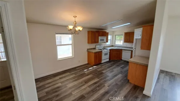 an empty room with wooden floor and a window