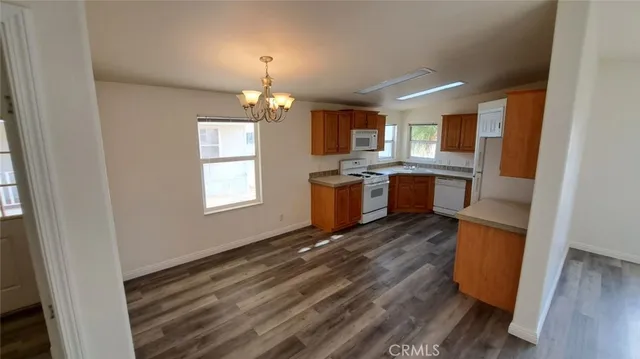 an empty room with wooden floor and a window