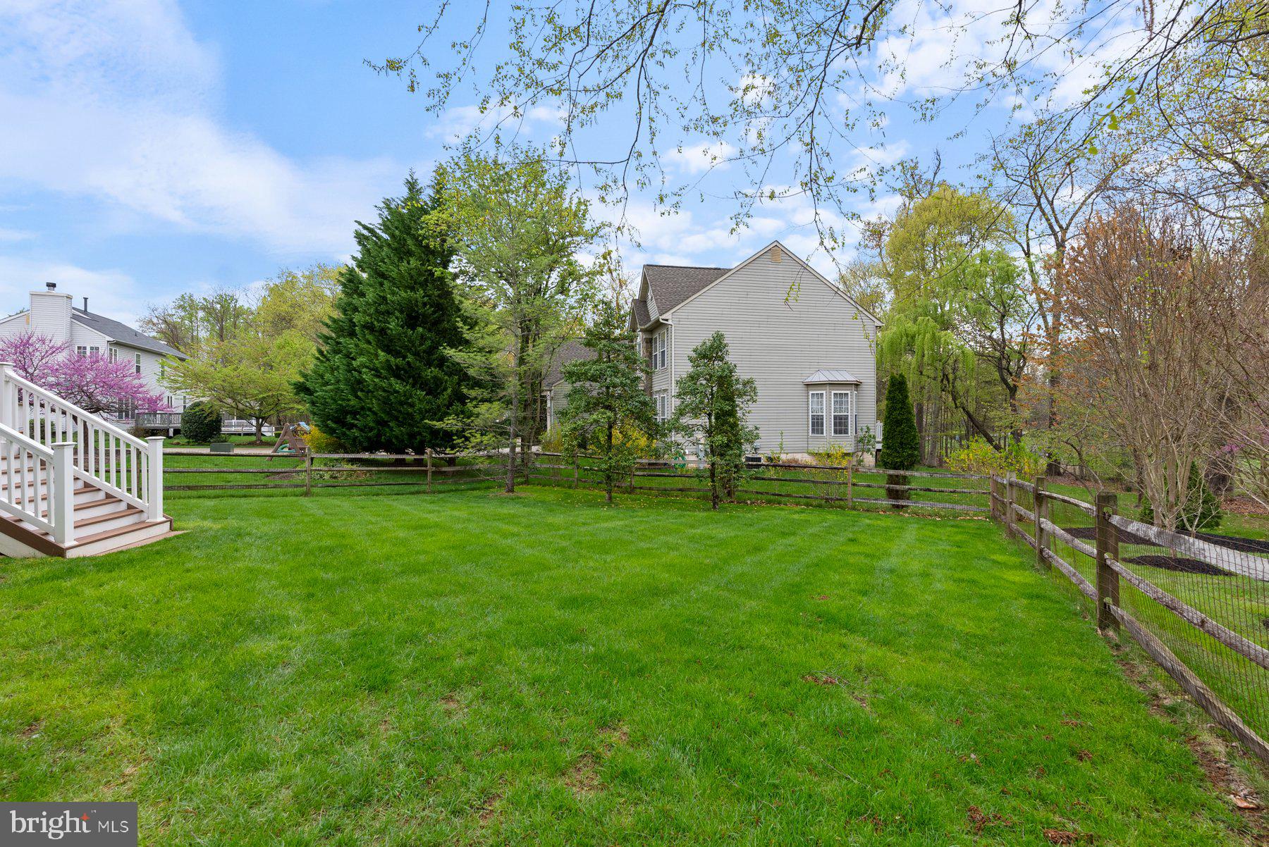 850 Sunny Chapel Road Odenton, MD 21113 - Photo 20 of 53 a backyard of a house with lots of green space and garden