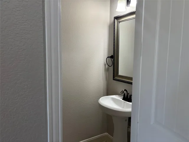a bathroom with a sink and mirror