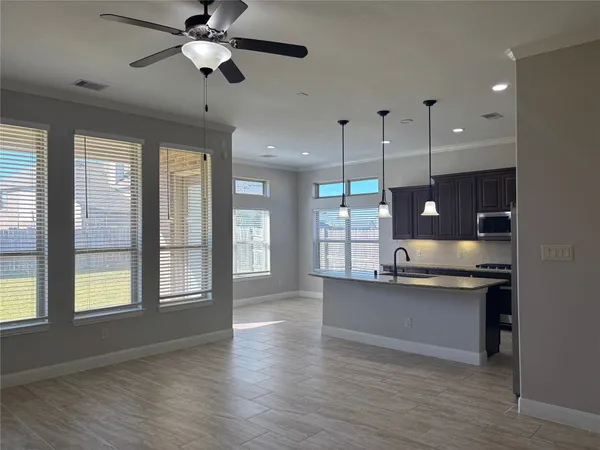 a view of a kitchen and a stove wooden floor