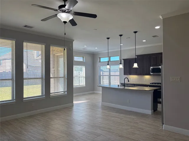 a view of a kitchen and a stove wooden floor