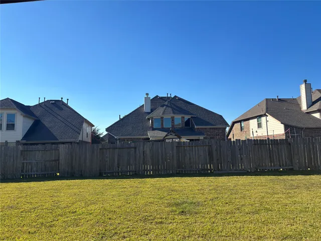 a view of a house with wooden fence