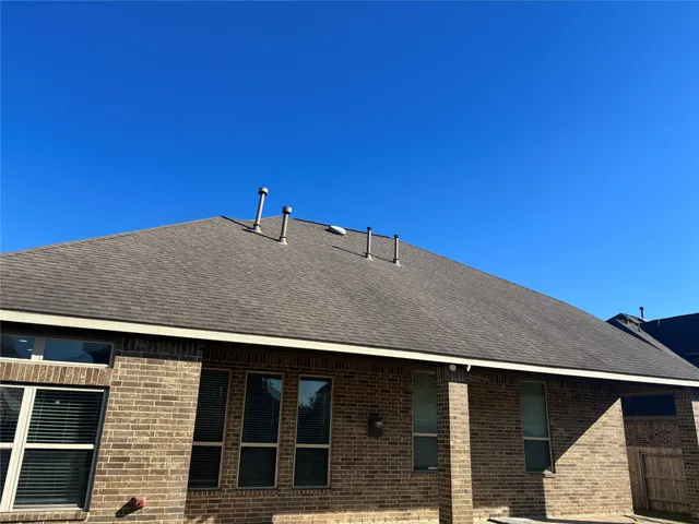 a view of house with backyard