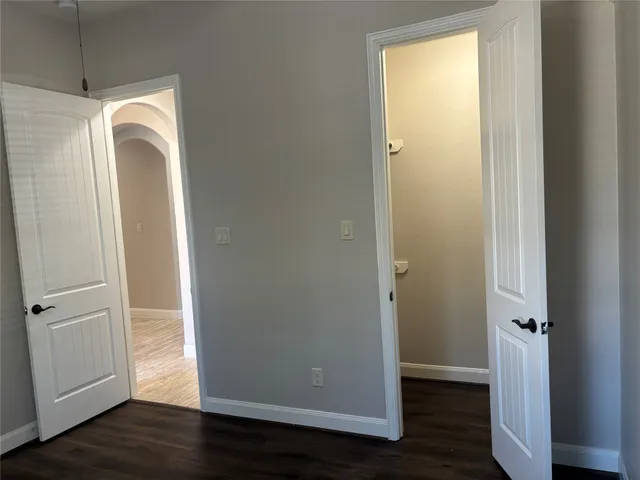 a view of walk in closet with wooden floor and window