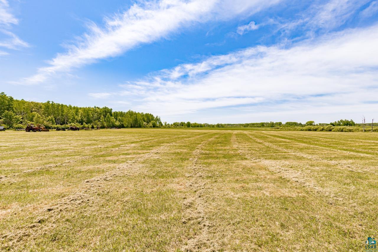 6606 Metso Road Kettle River, MN 55757 - Photo 9 of 84 Expansive open field with mown grass and natural tree lines bordering the perimeter