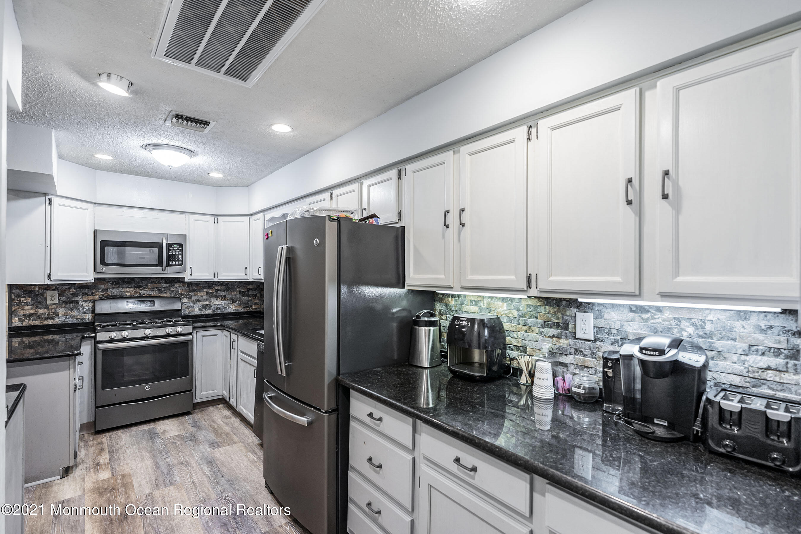 49 South Cooks Bridge Road Jackson, NJ 08527 - Photo 14 of 43 a kitchen with stainless steel appliances granite countertop a sink a stove and a refrigerator
