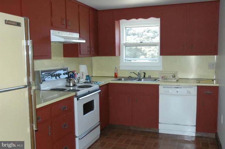 8302 Mapleville Road Mount Airy, MD 21771 - Photo 14 of 21 a kitchen with stainless steel appliances granite countertop a sink stove and refrigerator