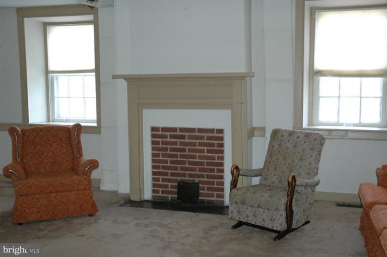 8302 Mapleville Road Mount Airy, MD 21771 - Photo 18 of 21 a living room with furniture and a fireplace