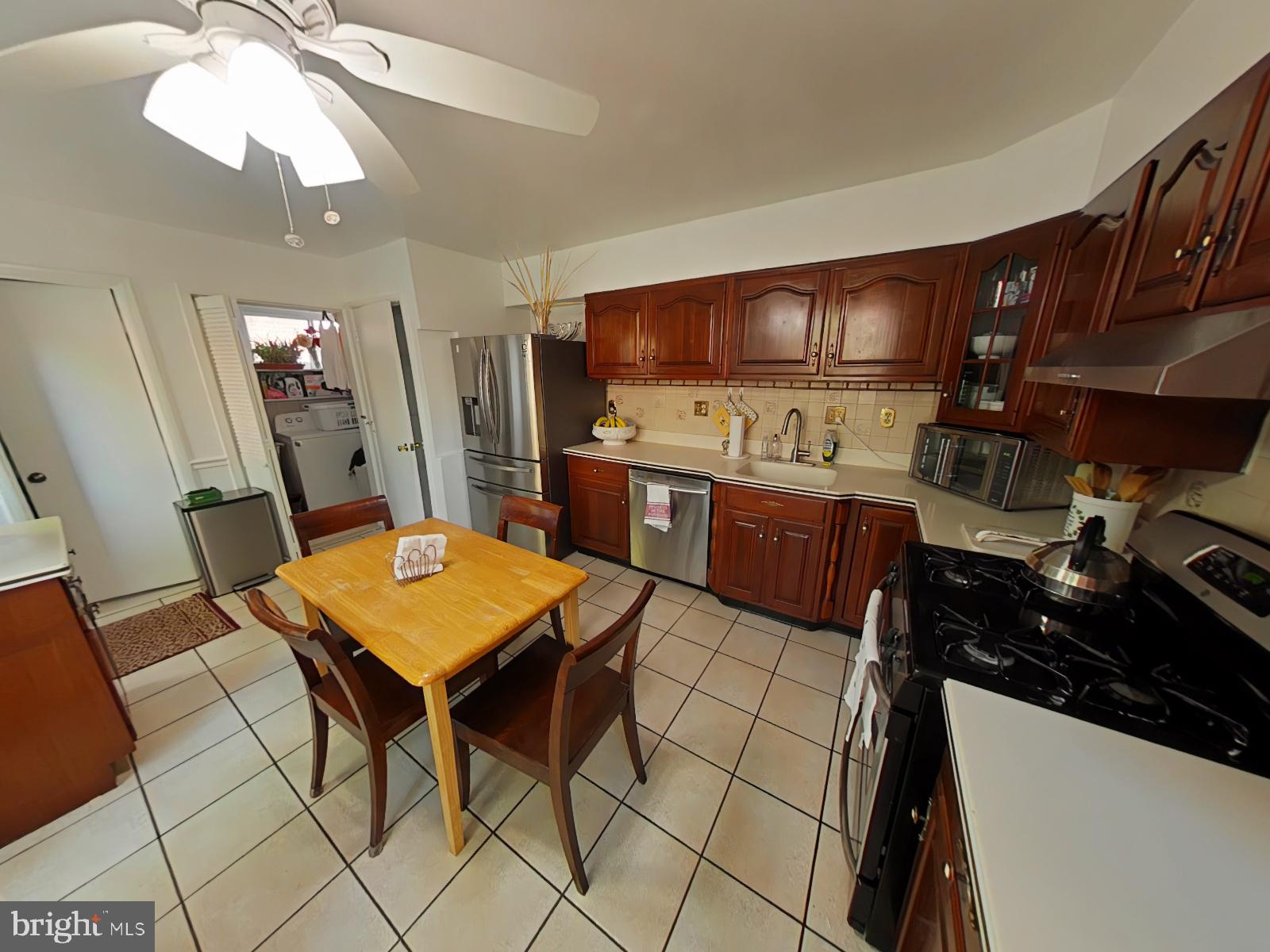 12807 Crisfield Road Silver Spring, MD 20906 - Photo 3 of 30 Cozy kitchen with warm wooden tones.