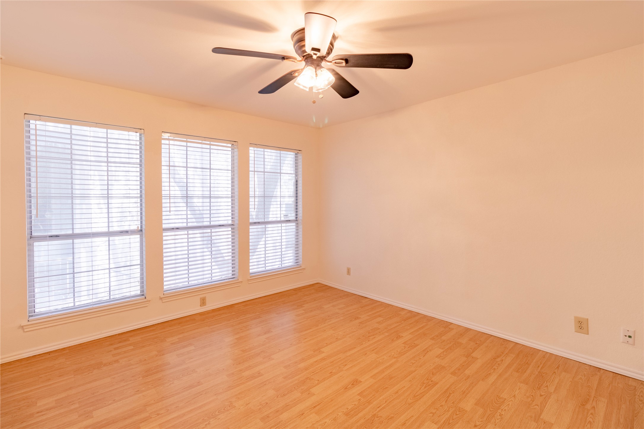 3809 Spicewood Springs Road, Unit 253 Austin, TX 78759 - Photo 14 of 23 Empty room featuring light wood-style flooring and a ceiling fan