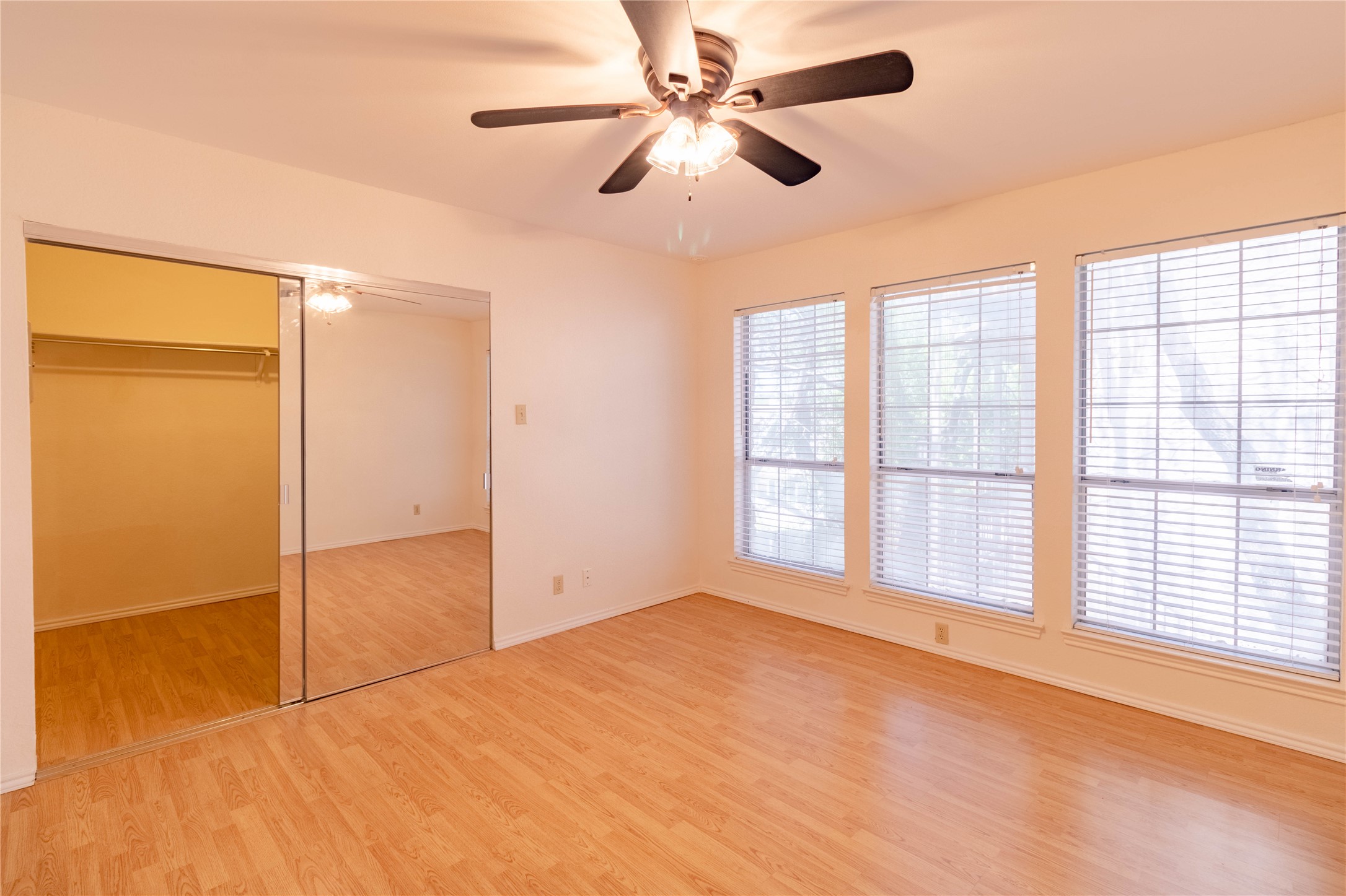 3809 Spicewood Springs Road, Unit 253 Austin, TX 78759 - Photo 15 of 23 Unfurnished bedroom with light wood-type flooring, a closet, and a ceiling fan
