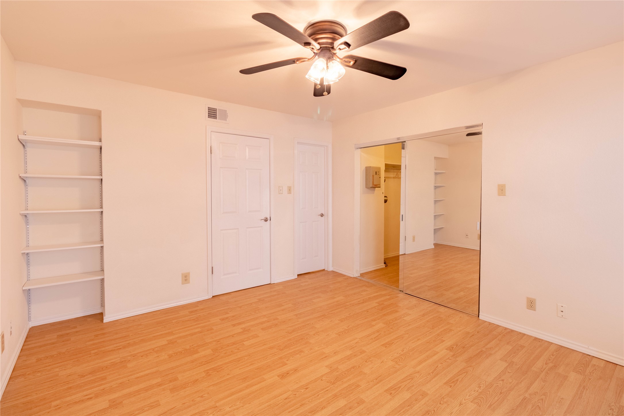 3809 Spicewood Springs Road, Unit 253 Austin, TX 78759 - Photo 16 of 23 Unfurnished bedroom with light wood-type flooring, a ceiling fan, and a closet