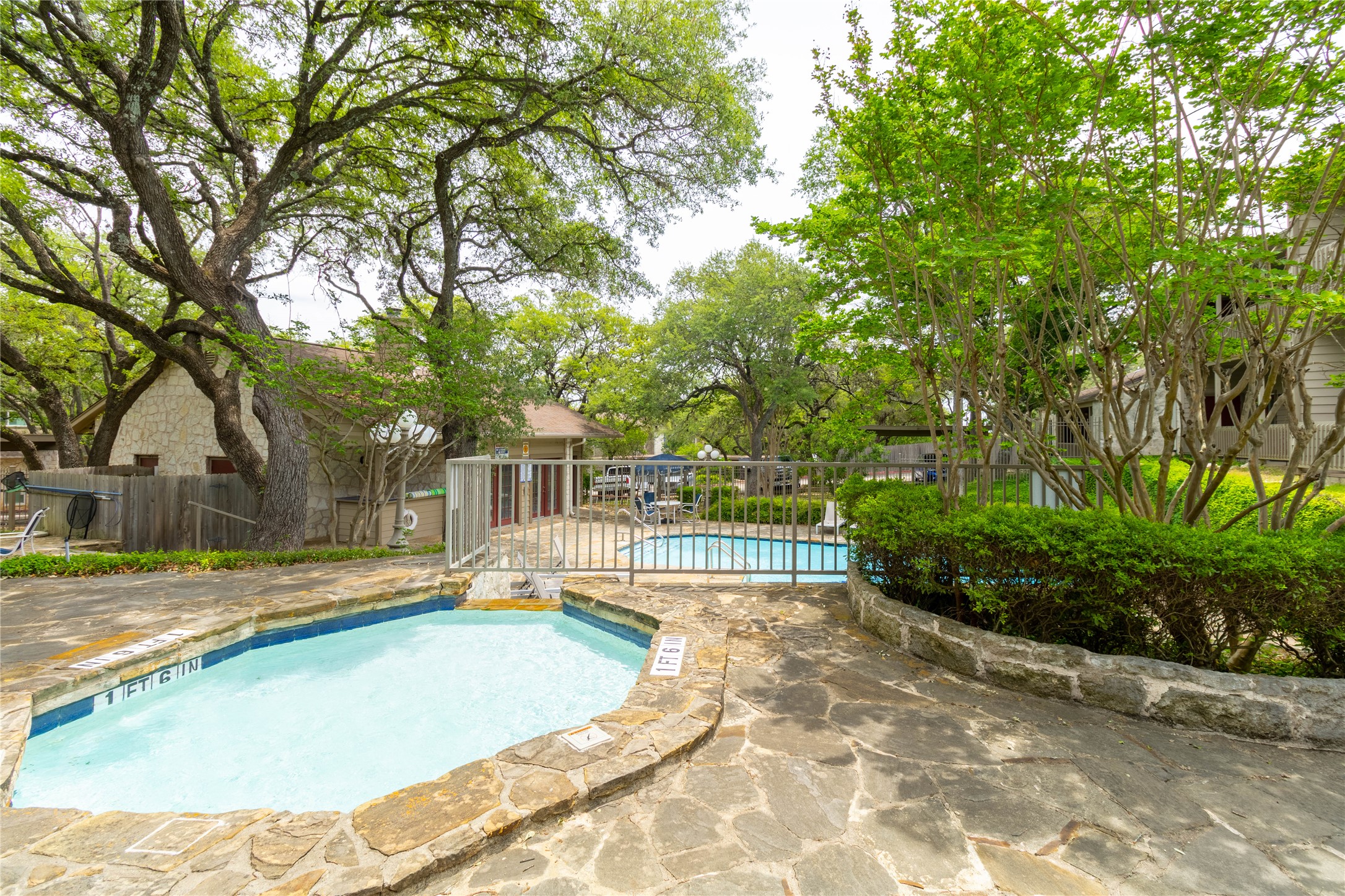3809 Spicewood Springs Road, Unit 253 Austin, TX 78759 - Photo 19 of 23 Community pool with a patio and a hot tub