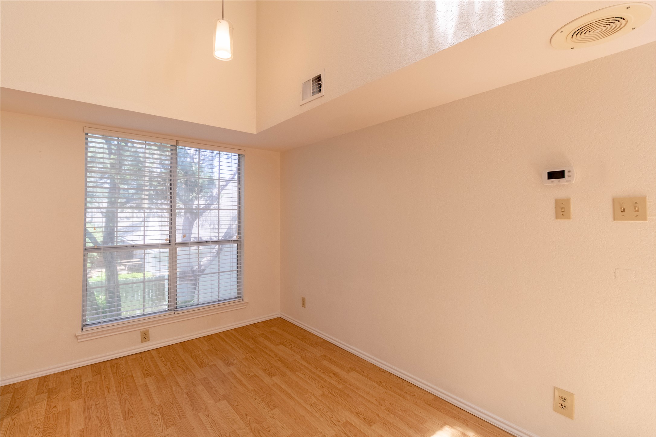 3809 Spicewood Springs Road, Unit 253 Austin, TX 78759 - Photo 7 of 23 Spare room with light wood-type flooring and a high ceiling