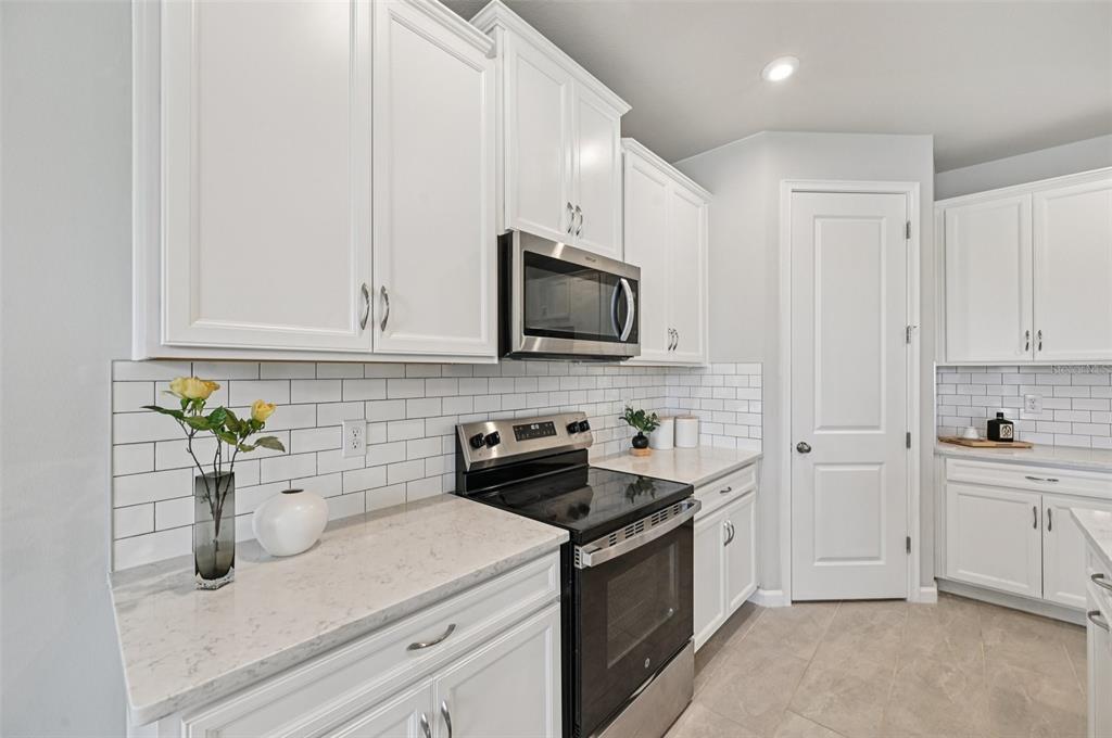20280 Concerto Place Venice, FL 34293 - Photo 12 of 37 a kitchen with a sink and white cabinets