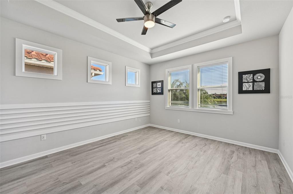 20280 Concerto Place Venice, FL 34293 - Photo 14 of 37 a view of an empty room with a window and wooden floor
