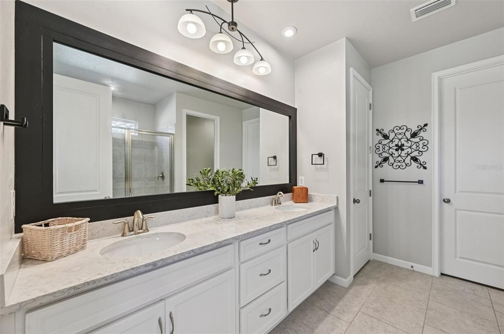 20280 Concerto Place Venice, FL 34293 - Photo 15 of 37 a bathroom with double sink and a mirror
