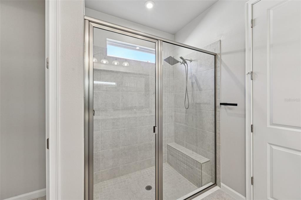 20280 Concerto Place Venice, FL 34293 - Photo 16 of 37 a bathroom with a glass shower door