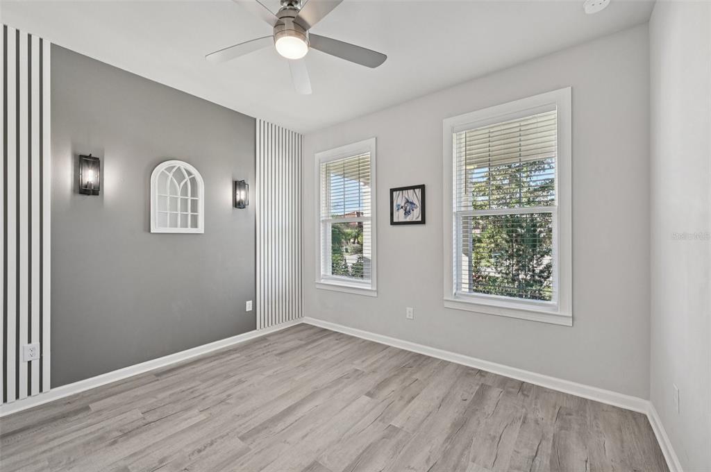 20280 Concerto Place Venice, FL 34293 - Photo 19 of 37 a view of an empty room with a window and wooden floor