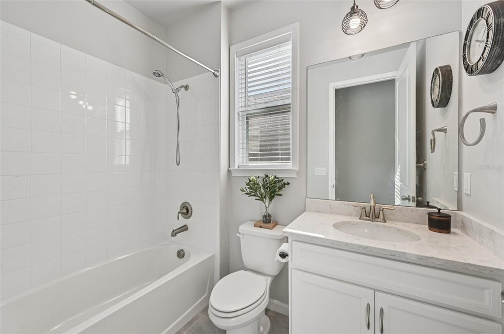 20280 Concerto Place Venice, FL 34293 - Photo 20 of 37 a bathroom with a granite countertop sink a toilet and shower