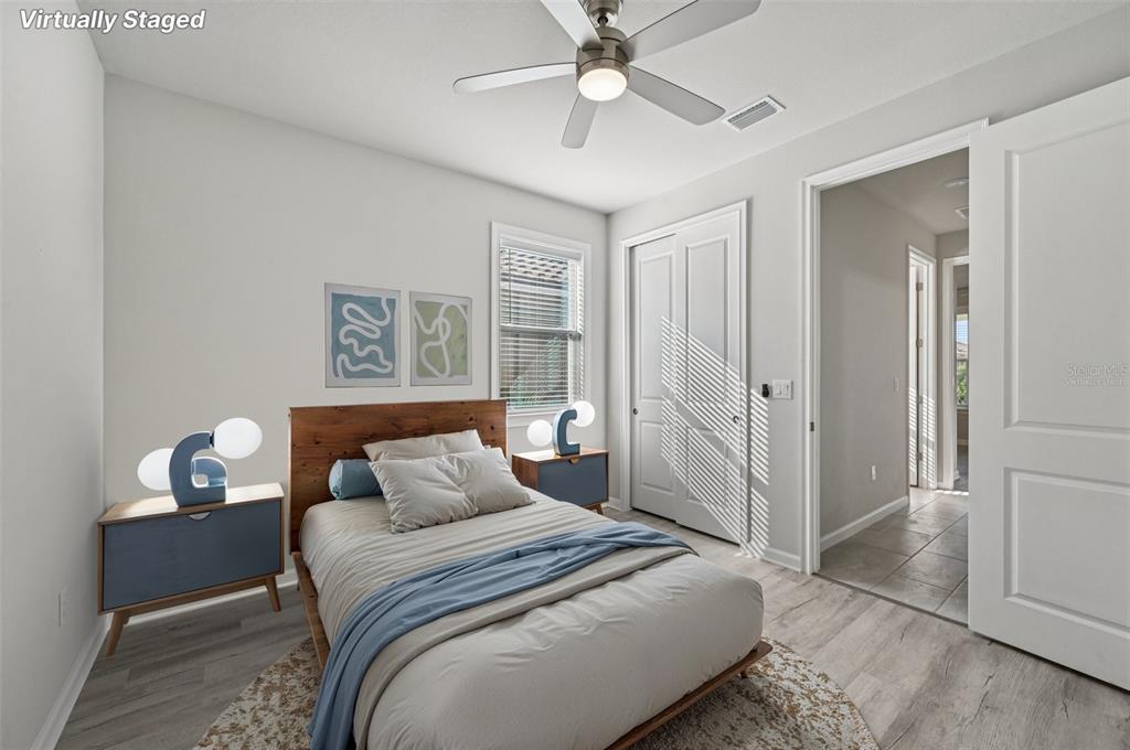 20280 Concerto Place Venice, FL 34293 - Photo 21 of 37 a bedroom with a bed and a chandelier