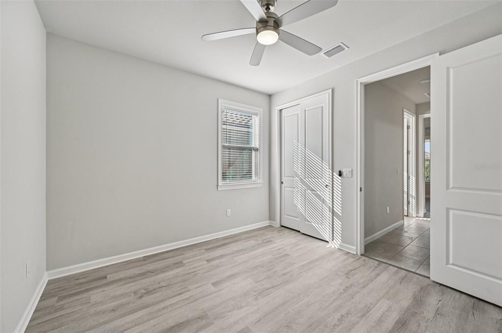 20280 Concerto Place Venice, FL 34293 - Photo 22 of 37 an empty room with wooden floor closet and windows