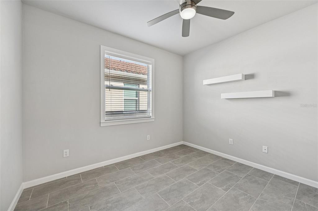 20280 Concerto Place Venice, FL 34293 - Photo 24 of 37 an empty room with a window and a fan