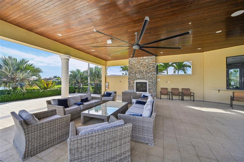 20280 Concerto Place Venice, FL 34293 - Photo 33 of 37 a outdoor space with patio the couches and a fireplace