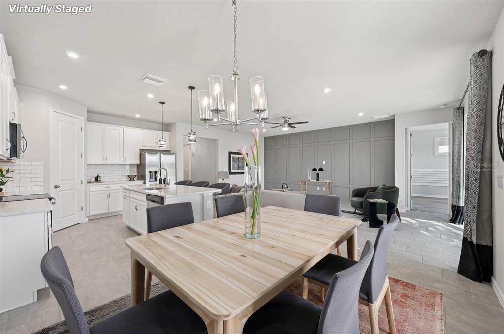 20280 Concerto Place Venice, FL 34293 - Photo 7 of 37 a large kitchen with kitchen island a dining table and chairs