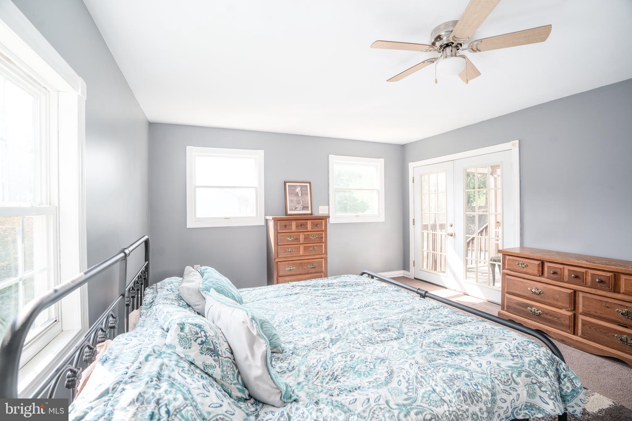 Primary bedroom with French doors to back porch