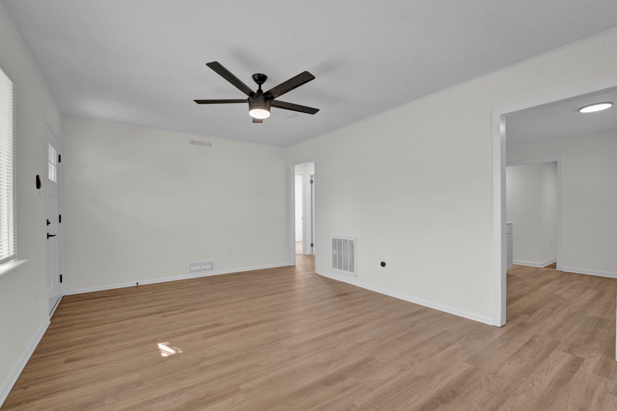 7829 Admiral Road Millington, TN 38053 - Photo 11 of 28 Empty room with ornamental molding, ceiling fan, and light hardwood / wood-style floors