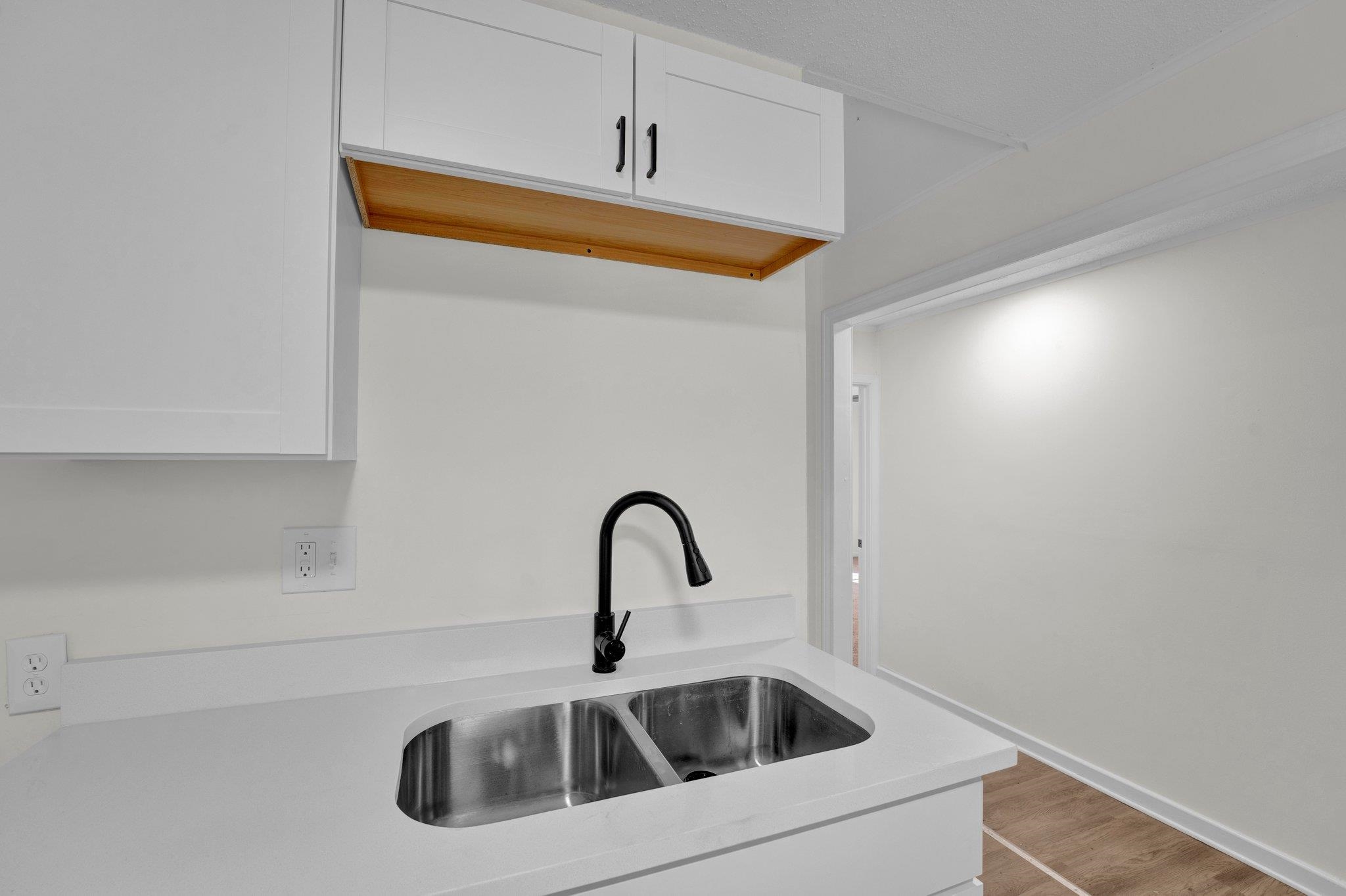 7829 Admiral Road Millington, TN 38053 - Photo 14 of 28 Kitchen with light hardwood / wood-style floors, white cabinetry, and sink