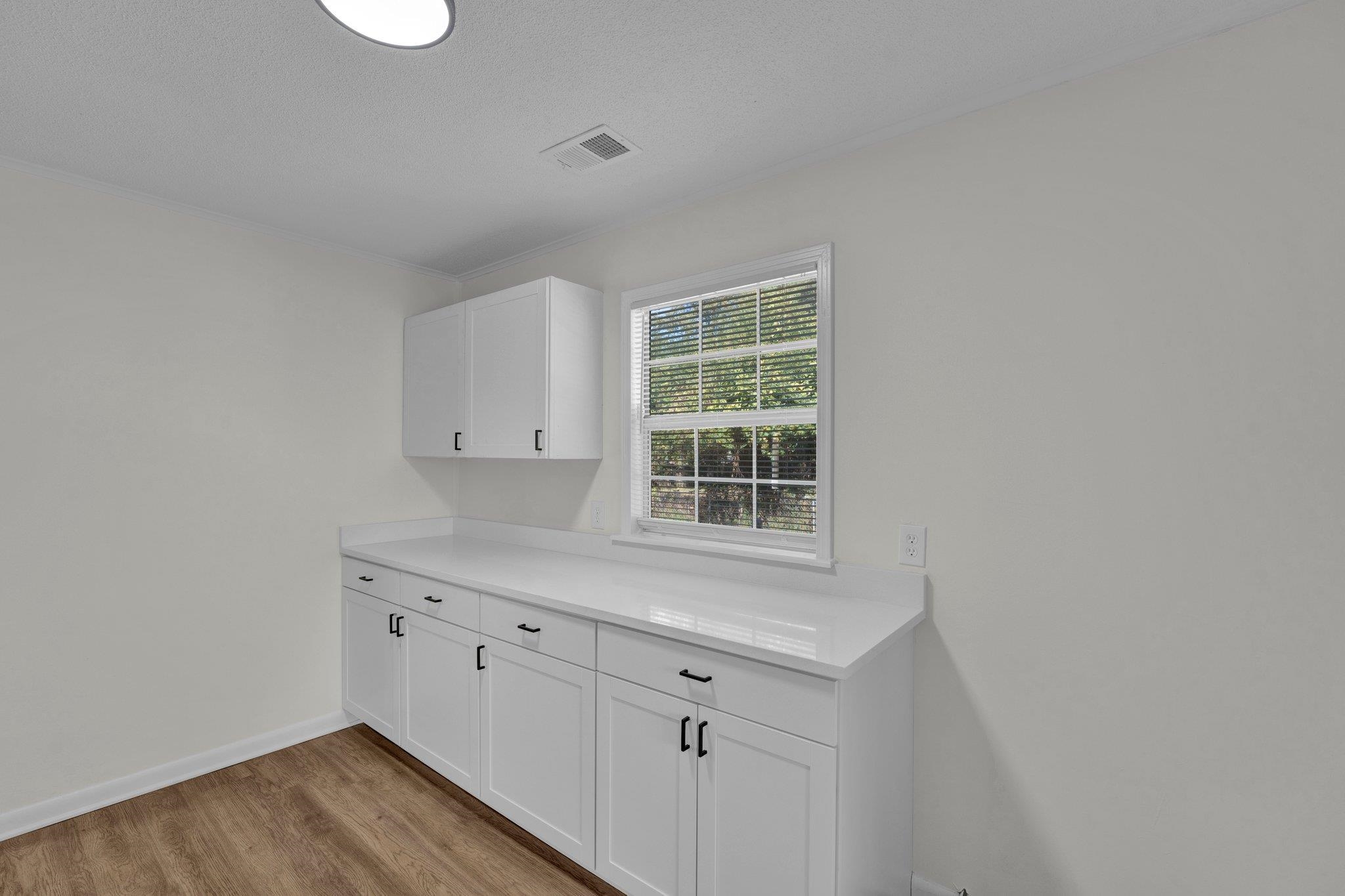 7829 Admiral Road Millington, TN 38053 - Photo 17 of 28 Interior space featuring white cabinetry, a textured ceiling, and light hardwood / wood-style flooring
