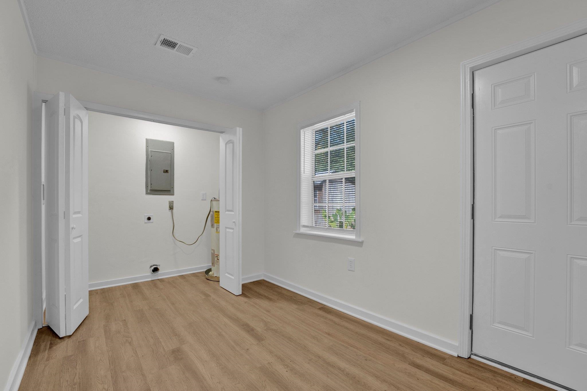 7829 Admiral Road Millington, TN 38053 - Photo 27 of 28 Laundry area with light wood-type flooring, electric dryer hookup, and electric panel