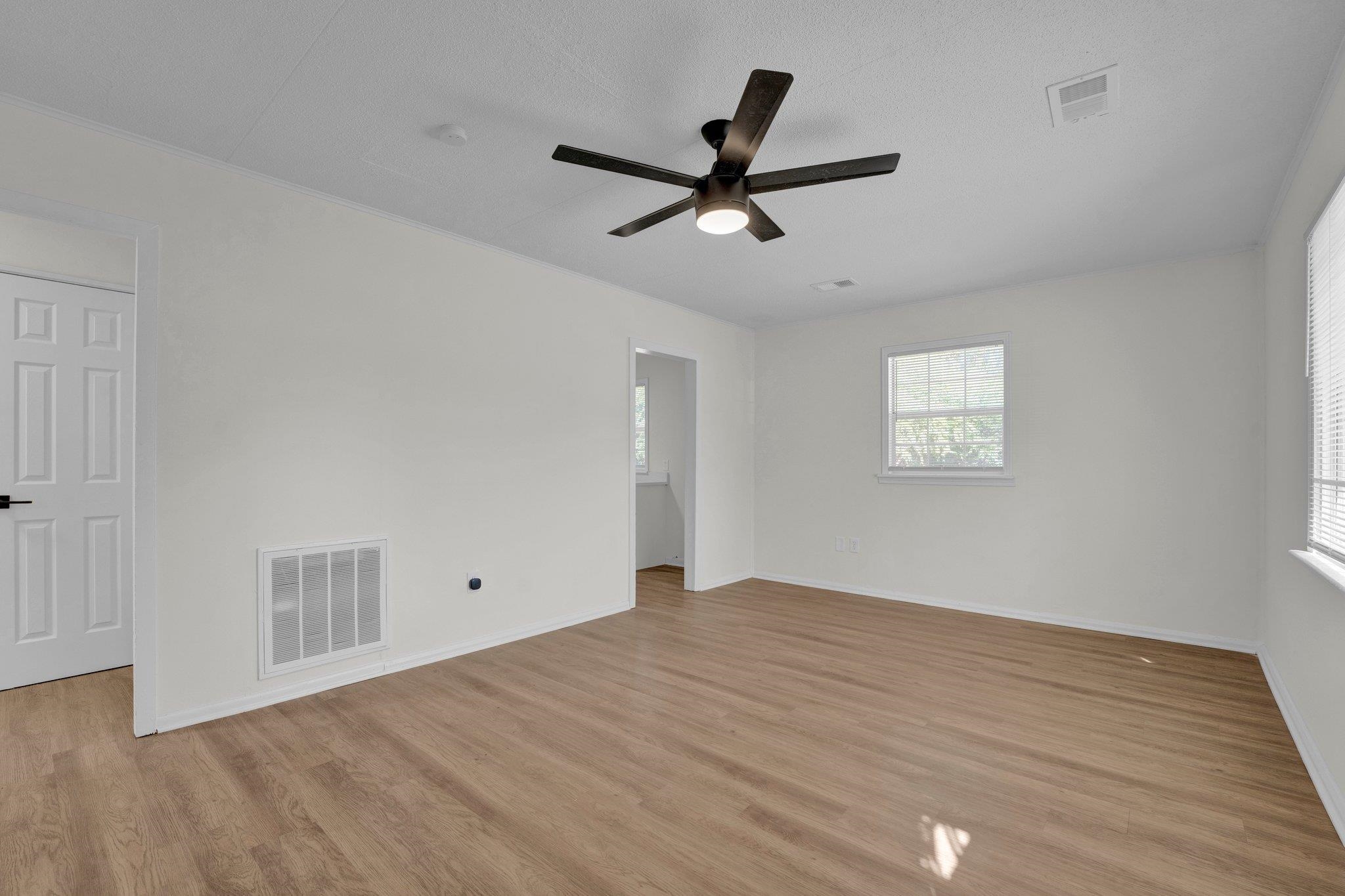 7829 Admiral Road Millington, TN 38053 - Photo 9 of 28 Empty room featuring light wood-type flooring, a textured ceiling, and ceiling fan
